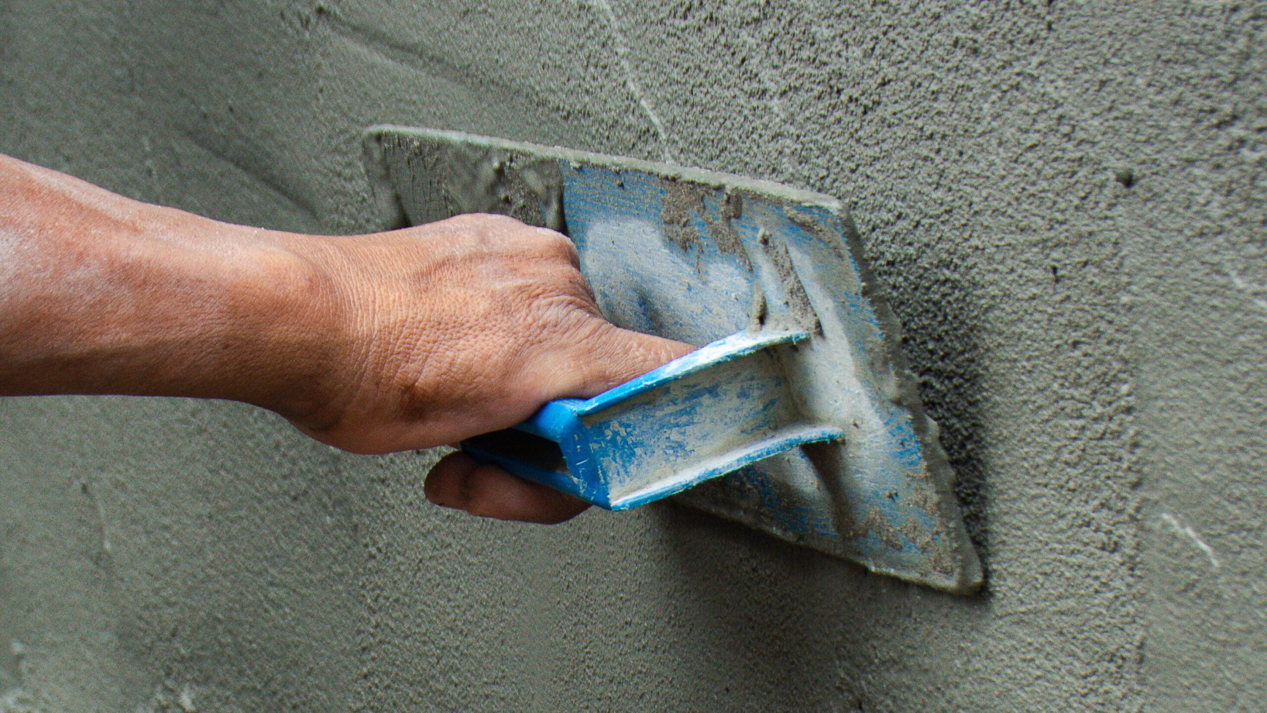 Construction workers in industrial buildings are plastering to build walls. Background image Industrial workers with plastering tools. Home improvement Professional quality concepts of the construction industry with skilled workers.